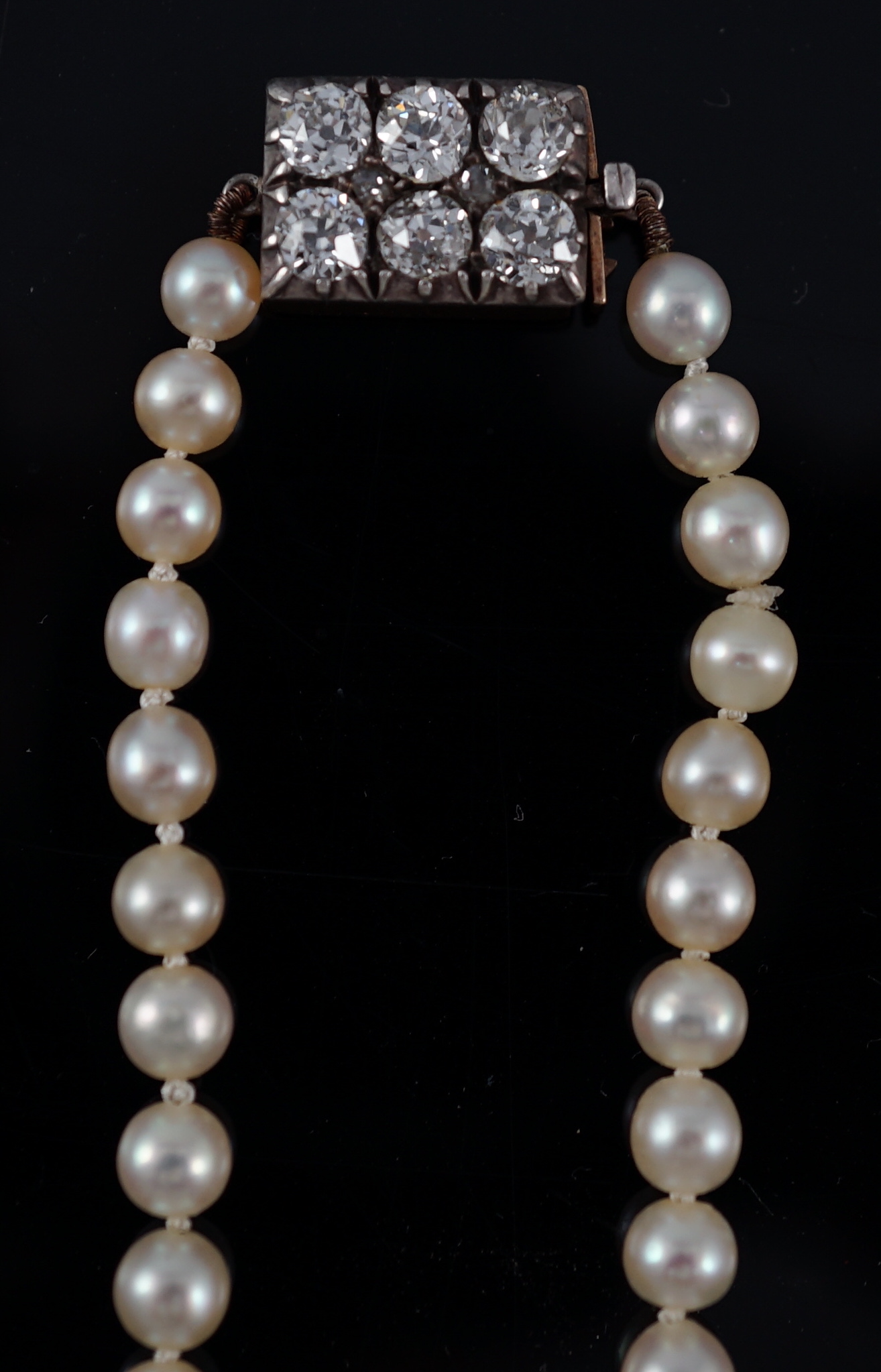 A late Victorian single strand graduated natural saltwater pearl necklace, with six stone old round cut diamond set silver and gold rectangular clasp